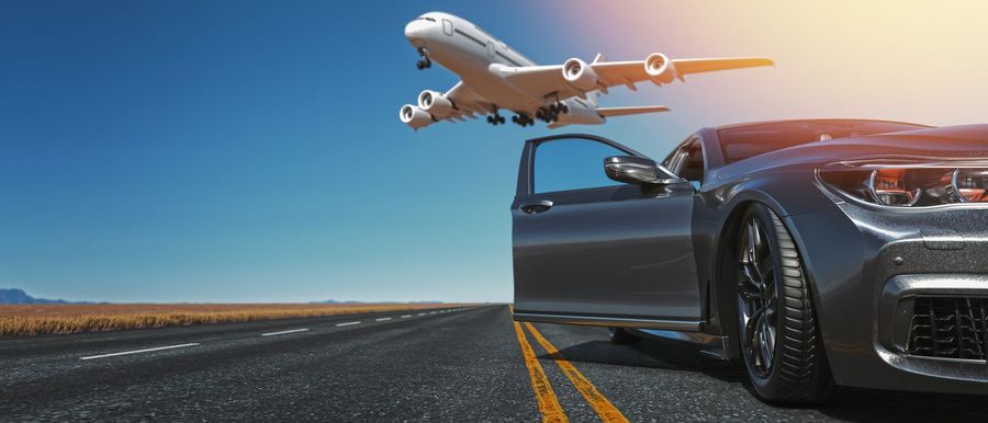 Aircraft climbing above a highway leading to the airport