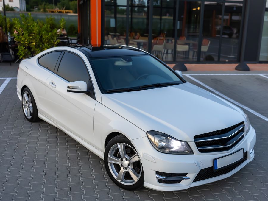 White sedan parked on a village street in Alstonville