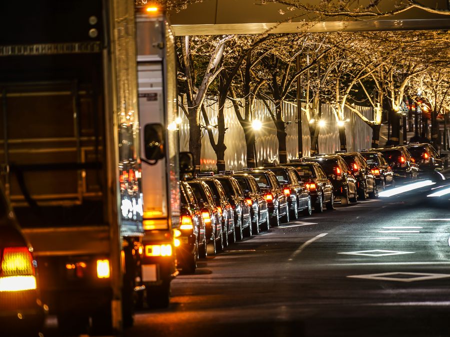 Street lit with lights and traffic on a busy event night